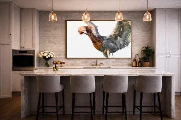 Reddish egret fine art wildlife photography displayed above a custom home bar, adding dramatic presence to a refined entertaining space.